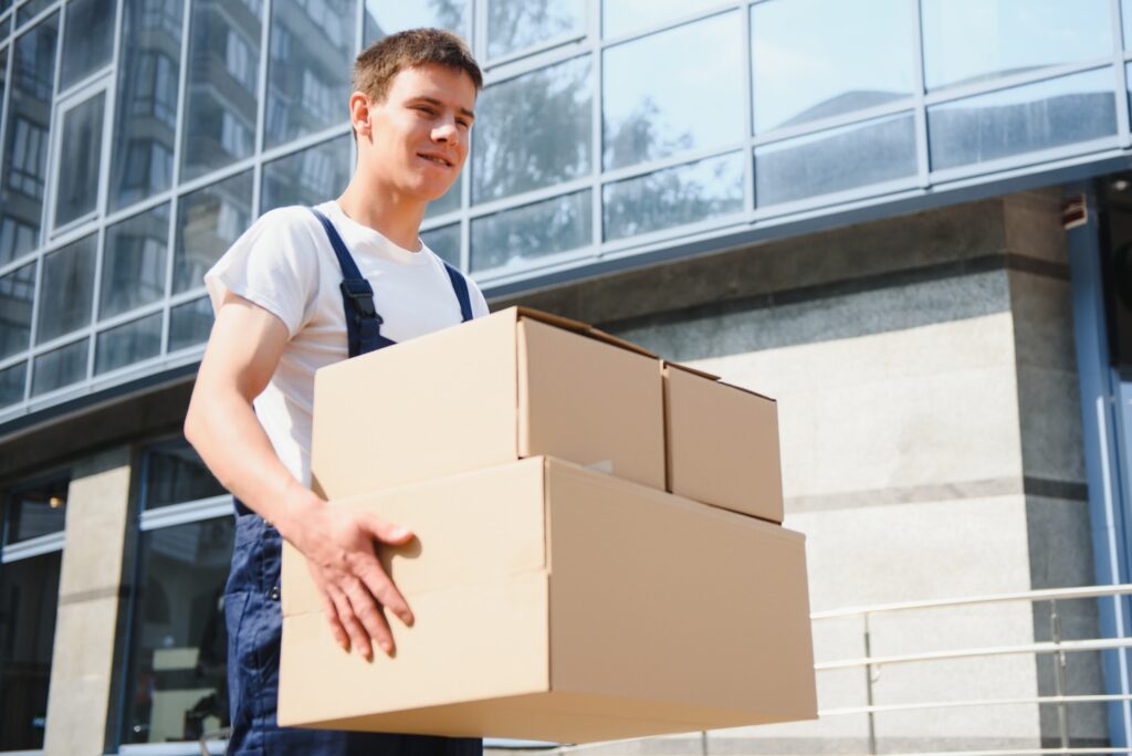 Postman with parcel box. Postal delivery service.