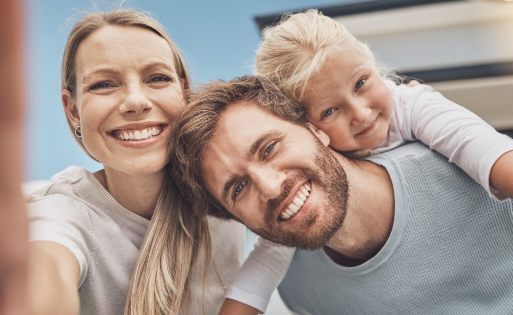 Selfie, happy and portrait of a family at their house after moving, relocation and buying a home. R